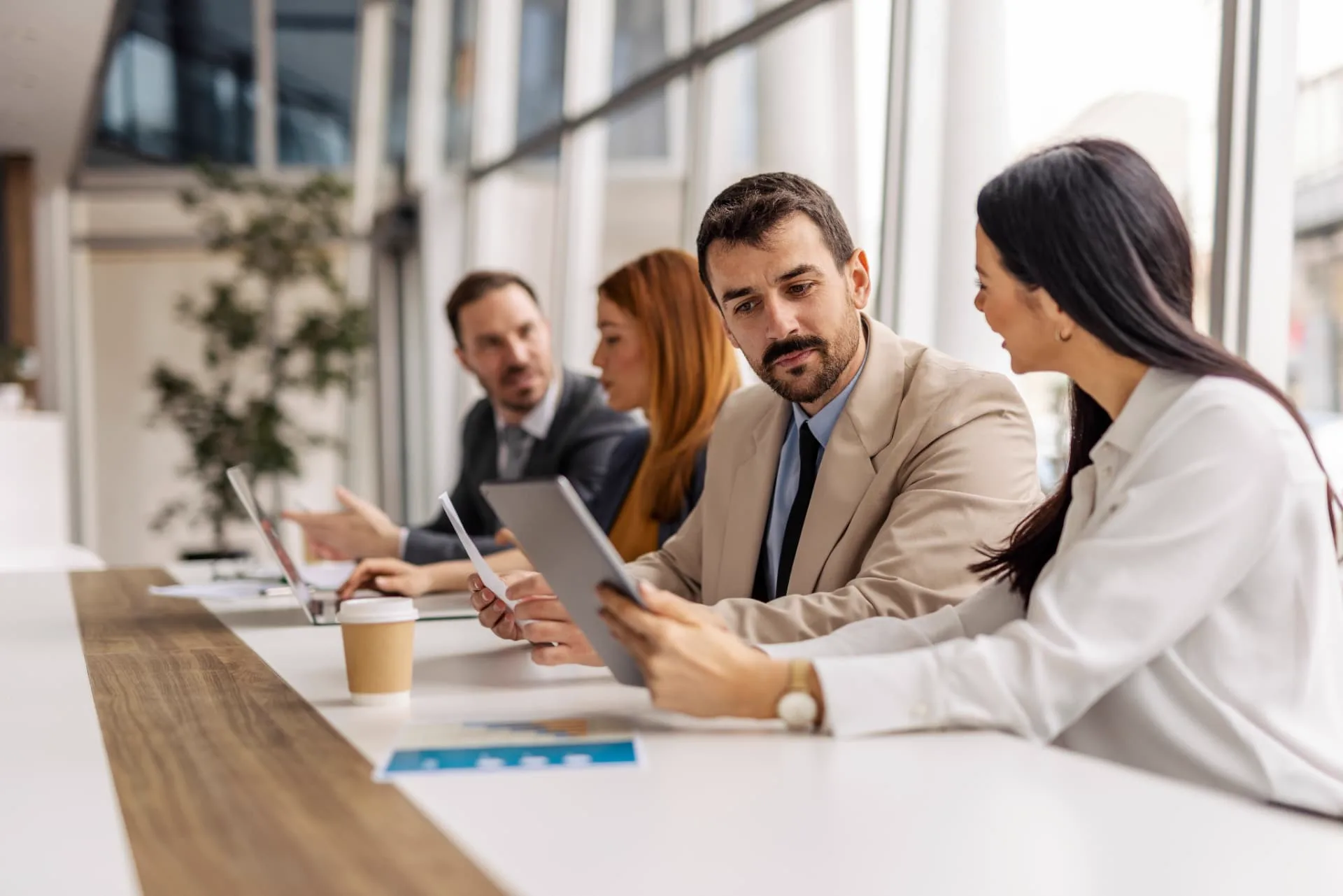 Business team reviewing leadership assessment results together in a modern office