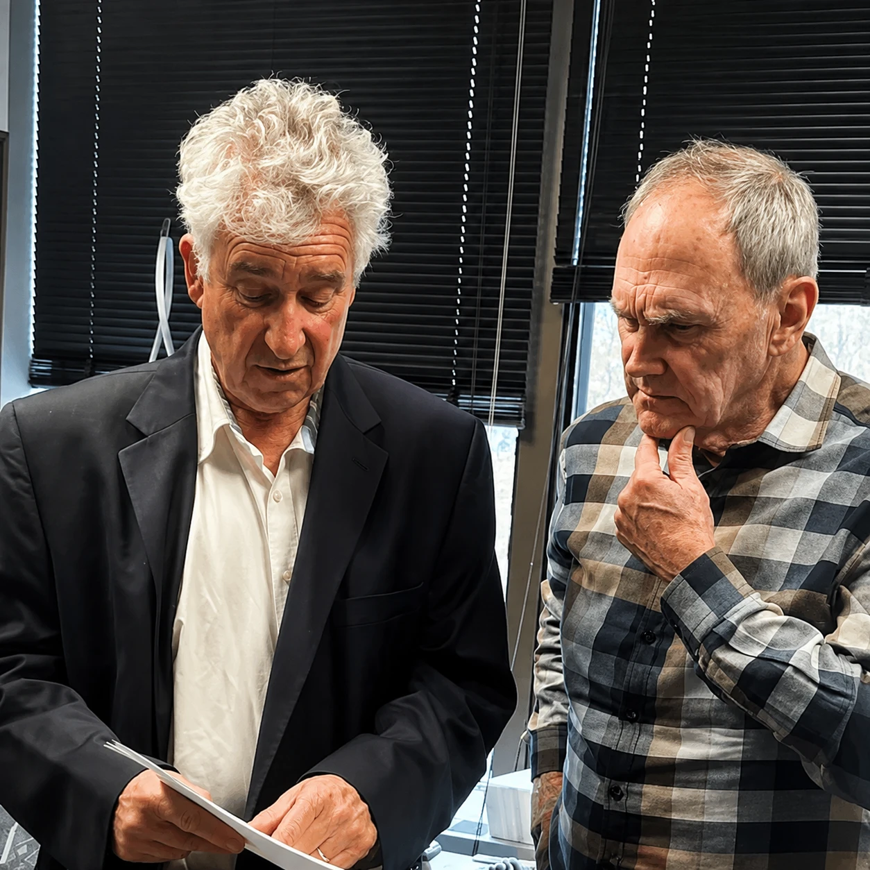 Stephen E. Kohn reviewing a 360° assessment report with a client in his office